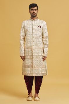 Cream sherwani with embroidered floral and honeycomb patterns. Comes with velvet dhoti pant.
Components: 2
Pattern: Embroidered
Type Of Work: Floral, Honeycomb
Neckline: Mandarin Collar
Sleeve Type: Full
Fabric: Sherwani: Jaquard Chikankari Lucknawi, Dhoti Pant: Velvet
Color: Cream
Other Details: 
Closure: Sherwani: Button
Note: Pocket square worn by model is not for sale
Occasion: Mehendi and Puja,Sangeet - Aza Fashions Cream Sherwani, Dhoti Pants For Men, Embroidered Sherwani, Dhoti Pants, Honeycomb Pattern, Velvet Color, Mandarin Collar, Pocket Square, Aza Fashion