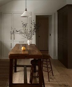 a wooden table sitting in the middle of a kitchen