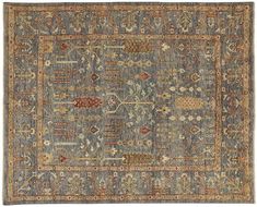 an antique rug with various colors and patterns on the carpet, including blue, beige, red