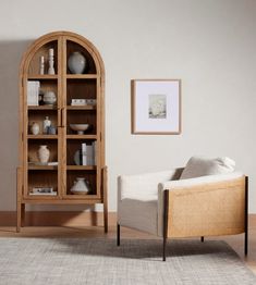 a living room with a chair and bookcase