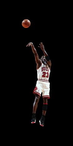 a basketball player jumping up in the air to dunk a ball with his right hand