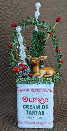 an ornament with a deer sitting on top of it's planter