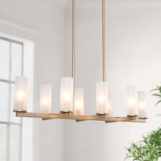 This exquisite and minimalist modern gold kitchen island pendant, with high-grade golden finish and eight-cylinder frosted glass lampshades, creates a hazy beauty in a mysterious and noble atmosphere. The pendant light includes 60-in adjustable hanging rods, giving you the flexibility to set the perfect height for your space. The large size width is suitable for a large space and can meet any special light requirements. It is capable of being dimmed when used with a dimmable bulb and compatible Gold And Glass Chandelier, Living Room Chandelier High Ceiling, Over Island Lighting, Lighting Above Sink, Gold Kitchen Decor, Modern Gold Kitchen, Dinning Room Light Fixture, Gold Kitchen Island, Dinning Room Lighting