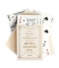 four playing cards with the words music goods co written in gold and black on them