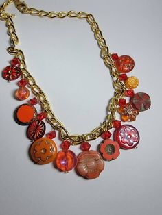 This fun charm necklace with vibrant red and orange hues will bring out your fiery side. Artisan czech glass beads topped with genuine swarovski bicone beads dangle from a 10K plated chunky chain. Chain is finished with a 10k gold plated lobster clasp. Red Dangle Charm Necklaces, Handmade Red Dangle Charm Necklaces, Red Handmade Dangle Charm Necklaces, Red Dangle Charm Necklaces With Lobster Clasp, Red Charm Necklace With Lobster Clasp, Red Metal Jewelry With Colorful Beads, Vibrant Orange Dangle Jewelry, Vibrant Red Dangle Jewelry, Orange Czech Glass Beaded Jewelry