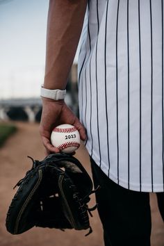 a person holding a baseball in their hand