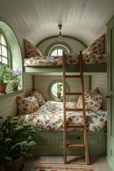 a bunk bed with flowers on it in a room next to a potted plant