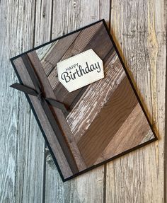 a card with a happy birthday tag on it sitting on top of a wooden table