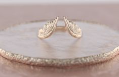 Fab and Sophisticated Angel Wings band in Bohemian Chic style. It has a comfortable fit inside the shank and you won't want to take it off! About this item: -Available in 10K/14K/18K gold in Rose/Yellow/White colors PLEASE NOTICE: This price is for the ring's sizes up to 8, if you need a bigger size > contact us for price & details! Please allow up to 1-2 weeks for production, as each item is made to order! You may also like: https://www.etsy.com/listing/777502252/pink-sapphire-engagement Engagement Rings With Wings, Rings With Wings, Elegant Winged Gold Jewelry, Angel Wing Ring Gold, V Wedding Band, Bohemian Chic Style, Wings Band, Wing Ring, Nature Wedding Ring