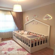 a baby's room is decorated in pink and white