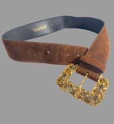 "Super sized and stunning, this 1 7/8\" wide suede belt was made in Italy with a bold gold tone floral sculpted buckle. Neutral mocha brown color easily coordinates with other colors. MEASUREMENTS BELT Width 1 7/8\" Length adjusts from 29 1/4 to 32\" BUCKLE Height 3 5/8\" Width 2 5/8\" Makes a thoughtful third anniversary gift (leather.) Label reads The Limited, genuine leather, made in Italy. In Very Good Vintage Condition. Some wear to materials consistent with age of belt. Shown with our 1960 Vintage Belt Buckles For Party, Vintage Belt Buckles With Removable Belt For Parties, Vintage Belts With Removable Buckle For Parties, Elegant Suede Belts For Formal Occasions, Italy Birthday, Valentine Gifts Jewelry, Velvet Midi Skirt, Third Anniversary, Leather Anniversary Gift