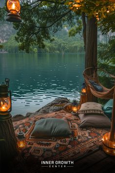 A cozy outdoor meditation space overlooking a serene lake, with lanterns and a hanging chair. Spiritual Retreat Ideas, Backyard Meditation Space, Spiritual Room Meditation Space, Boho Meditation Space, Healing Room Ideas, Outdoor Meditation Space, Camping Retreat