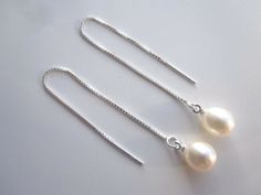 Stunning pair of 925 sterling silver pull through threader pearl earrings.  Approximately  8x9mm white freshwater pearls on a 925 sterling silver box chain supplied with butterfly fastener so you can wear them as an extra long dangle earrings.   The pearls are genuine freshwater pearls therefore each pearl is slightly different in shape and size and each pearls has it own unique natural blemishes.  Will be sent in a gift box The colour of the actual earrings might be slightly different to the ph White Pearl Drop Threader Earrings, Gift White Pearl Charm Threader Earrings, White Threader Earrings With Pearl Charm As Gift, White Pearl Threader Earrings With Charm, Sterling Silver Pearl Chain Earrings, Sterling Silver Pearl Earrings With Pearl Chain, Elegant Adjustable Threader Earrings, Elegant Sterling Silver Round Threader Earrings, Sterling Silver White Pearl Earrings With Pearl Chain