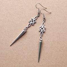 Embrace the warrior spirit with these Viking Spike Earrings, featuring antique silver charms and elongated spikes for a bold medieval allure. Key Features: Material: Antique silver charms and spikes Length: 3.2 inches with ear wire, 2.75 inches without Design: Intricately crafted to evoke a medieval aesthetic Make a statement with these distinctive earrings, perfect for those who seek to infuse their style with historical inspiration and feminine strength. To see more accessories please visit my Medieval Style Nickel-free Silver Earrings, Silver Jewelry Aesthetic Earrings, Silver Accessories Aesthetic, Vikings Accessories, Witch Earring, Medieval Earrings, Medieval Accessories, Nordic Jewelry, Feminine Strength