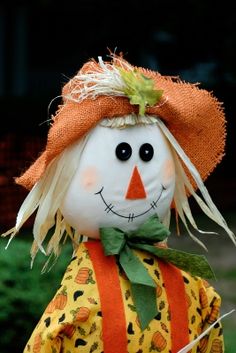 a close up of a scarecrow wearing an orange hat