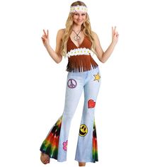 Flared pants and fringe make you the ultimate hippie for your next costumed event. This Women's Patchwork Hippie costume features flares with sparkly patches and tye-dye sections along the bell-bottom of the pants. A fringed halter top secures with hook and eye patches on the back and has a daisy chain along the waist. The look is topped with a daisy chain headband to create a San Francisco ready look! Bottoms Costume, Hippie Costume Diy, Hippie Outfits 70s, 70s Costume, Hippie Halloween, Moda Hippie, Outfits 70s, Estilo Hippy, Mode Hippie