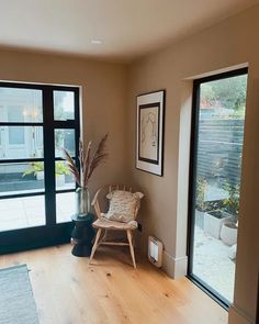 a living room filled with furniture next to two large sliding glass doors and a wooden floor