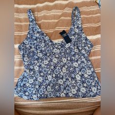 Blue Tank With Floral Print. Size Medium Casual Blue Printed Tank Top, Navy Summer Tops For Vacation, Navy Fitted Tops For Summer, Navy Fitted Top For Summer, Blue Floral Print Summer Top, Blue Printed Tank Top For Vacation, Blue Floral Print Tops For Vacation, Blue Printed Top For Vacation, Fitted Blue Printed Tops