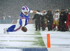 a football player in mid air after catching a ball