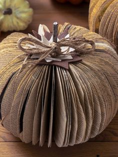 an open book pumpkin sitting on top of a wooden table