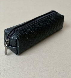 "Simply design handcraft black textured cowhide leather pencil case. Leather pencil case is perfect for those who goes in school, study, work in the office, at home, on the train, or the go! This pouch can hold your small brushes,mascara, eyeliner and eyelash comb. Unlined SIZE: W*H*L 5*5*19 cm (1.96*1.96*7.48 \") Made in Latvia SHIPPING: I need 1-3 business days to finish your order. I use USPS for shipping with added tracking number Express Shipping is performed with FedEx or UPS ( phone numbe Black Rectangular Pencil Case With Zipper, Black Leather Rectangular Pencil Case, Black Pouch With Pen Holders For School, Black Rectangular Pouch For Gifts, Black Rectangular Zipper Pencil Case, Black Rectangular Pouch As Gift, Black Rectangular Pouch Gift Case, Rectangular Black Pouch For Gift, Black School Pouch With Pen Holders