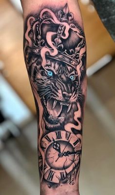 a man's arm with a tiger and clock tattoo design on it, done by an artist