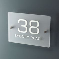 a glass sign with the words sydney place on it