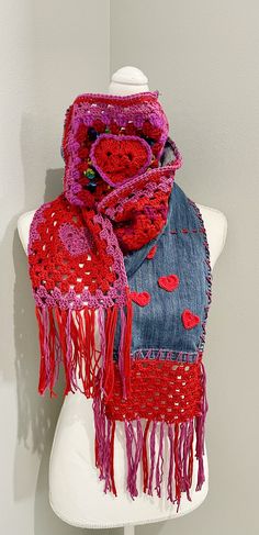 a mannequin wearing a red scarf with hearts on it