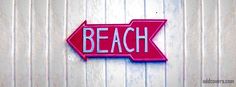 a pink sign that says beach on it and an arrow pointing to the opposite direction