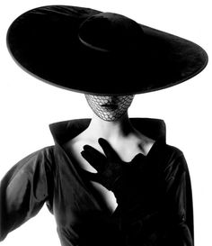 a woman wearing a black hat and gloves