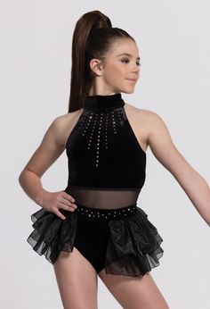 a woman in a black leotard and skirt