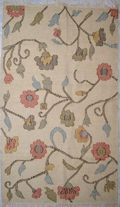 an old rug with flowers and vines on it