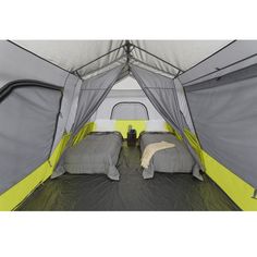 the inside of a tent with two beds in it