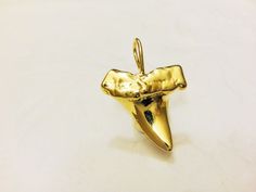 This vermeil  shark tooth is a nice piece for necklaces, bracelets and earrings. It measures about 22x15mm including loop. It is 18k gold plated over 925 sterling silver (vermeil), shiny finished.1 pc. SILVER VERSION:  https://www.etsy.com/listing/219670150/925-sterling-silver-oxidized-shark-toothMATTE VERMEIL VERSION:   https://www.etsy.com/listing/242934154/vermeil-18k-gold-over-925-sterlingSHINY ROSE GOLD VERSION:   https://www.etsy.com/listing/464997918/rose-gold-vermeil-18k-rose-gold-over-9 Dainty Shark Tooth Necklace Real Gold, Sharks Tooth Jewelry, Gold Shark Tooth Necklace, Tiger Tooth Pendant, Sand Tiger Shark Tooth Necklace, Silver Shark, Tooth Charm, Shark Tooth, Shark Teeth