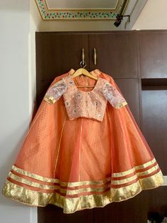 Custom made beautifull costume with double layers skirt of brocade and net. It comes with golden tassels, dupatta of your choice and blouse  Discuss with our designers about your dancing dress . Negotiation on price as per quantity.  - The first layer is banarasi brocade - the top layer is fine quality net  - full circle skirt with flare 7.5 meters  - when the dancer will spin the skirt takes full circle - get your outfit custom made with us  - leave a message to discuss - the item will be made as per your measurements  - can be created in any color Bollywood dance costume- Kalbelia dance costume- Indian dance - Pakistani dance - wedding costume - dance - ghoomar - Tera tali dance Orange Organza Set For Festivals, Traditional Peach Dress With Drape, Orange Organza Festival Set, Festival Orange Organza Set, Bollywood Style Unstitched Peach Traditional Wear, Bollywood Style Peach Traditional Wear With Unstitched Blouse, Orange Organza Sharara For Festivals, Bollywood Peach Traditional Drape Sets, Fitted Peach Traditional Wear With Zari Work