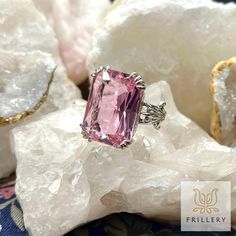 Stand out from the crowd with this exquisite ring that combines classic elegance with a touch of pink perfection. The intricate detailing on this stunning piece will have you feeling like a true fashion icon wherever you go. Size 5. Like so many of Frillery's vintage and thrifted pieces, this one might show minor signs of age or wear. Elegant Pink Gemstone Ring, Formal Pink Morganite Rings, Formal Pink Ruby Ring With Accent Stones, Pink Ruby Ring With Accent Stones For Formal Occasions, Heirloom Pink Jewelry With Center Stone, Pink Fine Jewelry Rings For Formal Occasions, Classic Pink Ruby Ring For Formal Occasions, Elegant Pink Crystal Open Ring, Pink Open Ring With Prong Setting