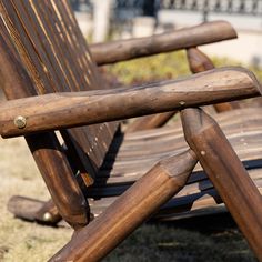 two wooden benches sitting on top of a grass covered field