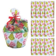 a bag filled with candy sitting next to some wrapping paper on top of each other