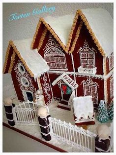 a gingerbread house is decorated with icing and frosting on the outside, along with other decorations