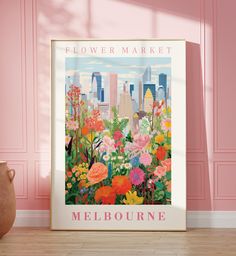 a flower market poster in front of a pink wall with a vase on the floor