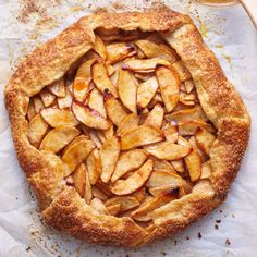 an apple pie is shown on a white surface