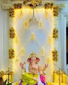 an elephant statue sitting on top of a bed in front of a white and yellow wall