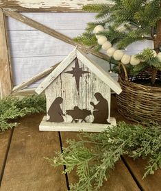 a nativity scene is displayed in front of a christmas tree