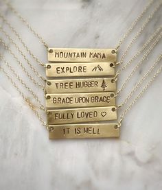 Personalize this gold bar necklace with any word that has special meaning to you or to a loved one! Give a word of encouragement to someone going through a hard time - "BRAVE" Remind her how valuable she is - "PRICELESS"Does she light up your day? If so, tell her! - "SHINE"Going on a trip? - "WANDER"Remind her it's gonna be ok. Keep your chin up - "HOPE"● 16" chain ● Completely customizable! Just message me!● Bar measures 40x8mm● Solid brass bar● Gold filled chain● Handmade by Stuart & Lisa Everyday Rectangular Engraved Text Necklace, Everyday Rectangular Necklace With Engraved Text, Everyday Rectangular Necklaces With Engraved Text, Everyday Inspirational Personalized Necklaces, Personalized Gold Bar Necklace For Everyday, Meaningful Nameplate Necklace For Everyday, Everyday Engraved Nameplate Bar Necklace, Everyday Personalized Gold Bar Necklace, Everyday Meaningful Nameplate Necklace