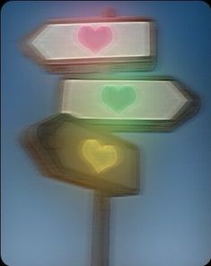 three street signs with hearts painted on them