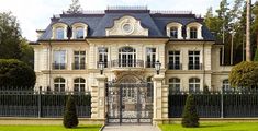 a large house with an iron gate in front of it