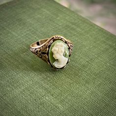 Oxidized silver plated or antiqued brass ring which is adjustable and has oak leaf details on the sides. In the center is a 14x10mm green and white girl cameo. Green Lady, Cameo Ring, Oak Leaf, Brass Ring, Oxidized Silver, Antique Rings, Green And White, Antique Brass, Antique Silver