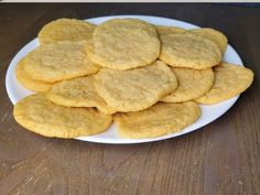 a white plate filled with cookies on top of a wooden table