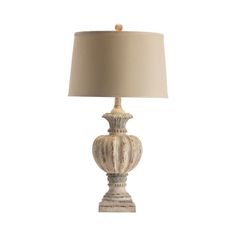 a white lamp with a beige shade on it