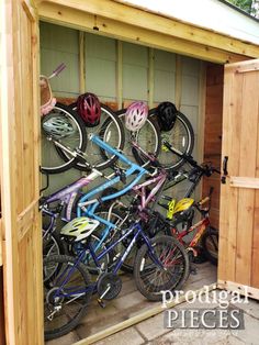 several bicycles are parked in a storage shed